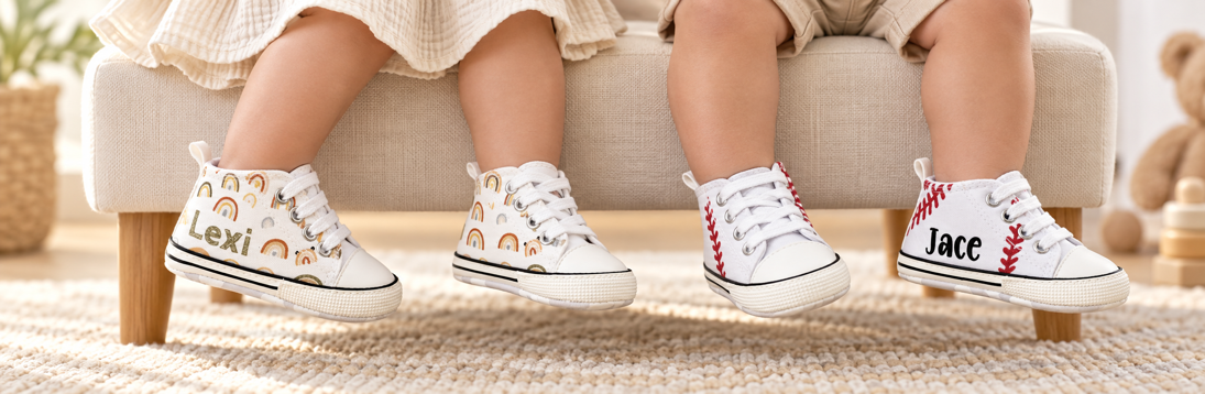 Close-up of two toddlers wearing Lexi rainbow shoes and Jace baseball shoes